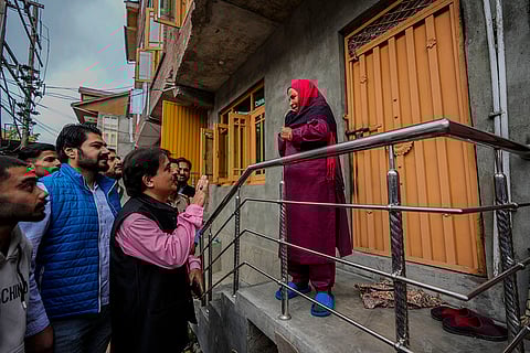 2024 J&K Elections: Ashok Bhat, left, BJP candidate talks to a voter, while campaigning door-to-door